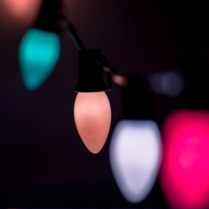 Purple Grinch-themed string lights glowing on a dark background